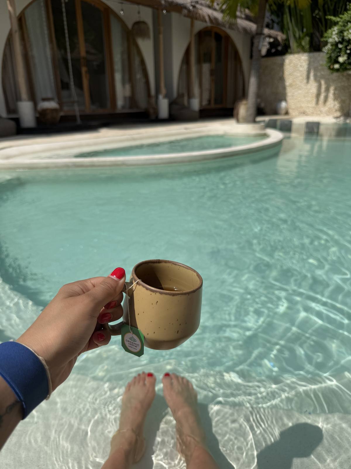 Feet in the water, tea in hand
