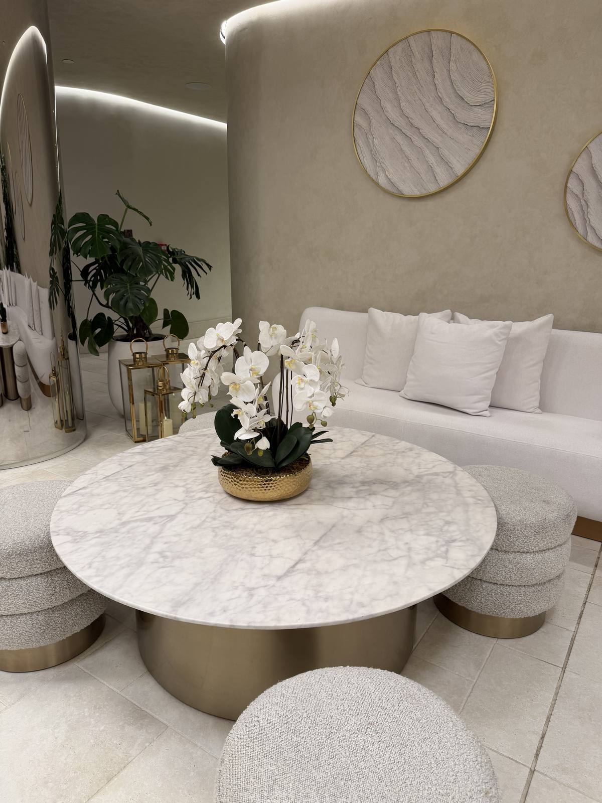 A quiet lounge set with candles and soft seating