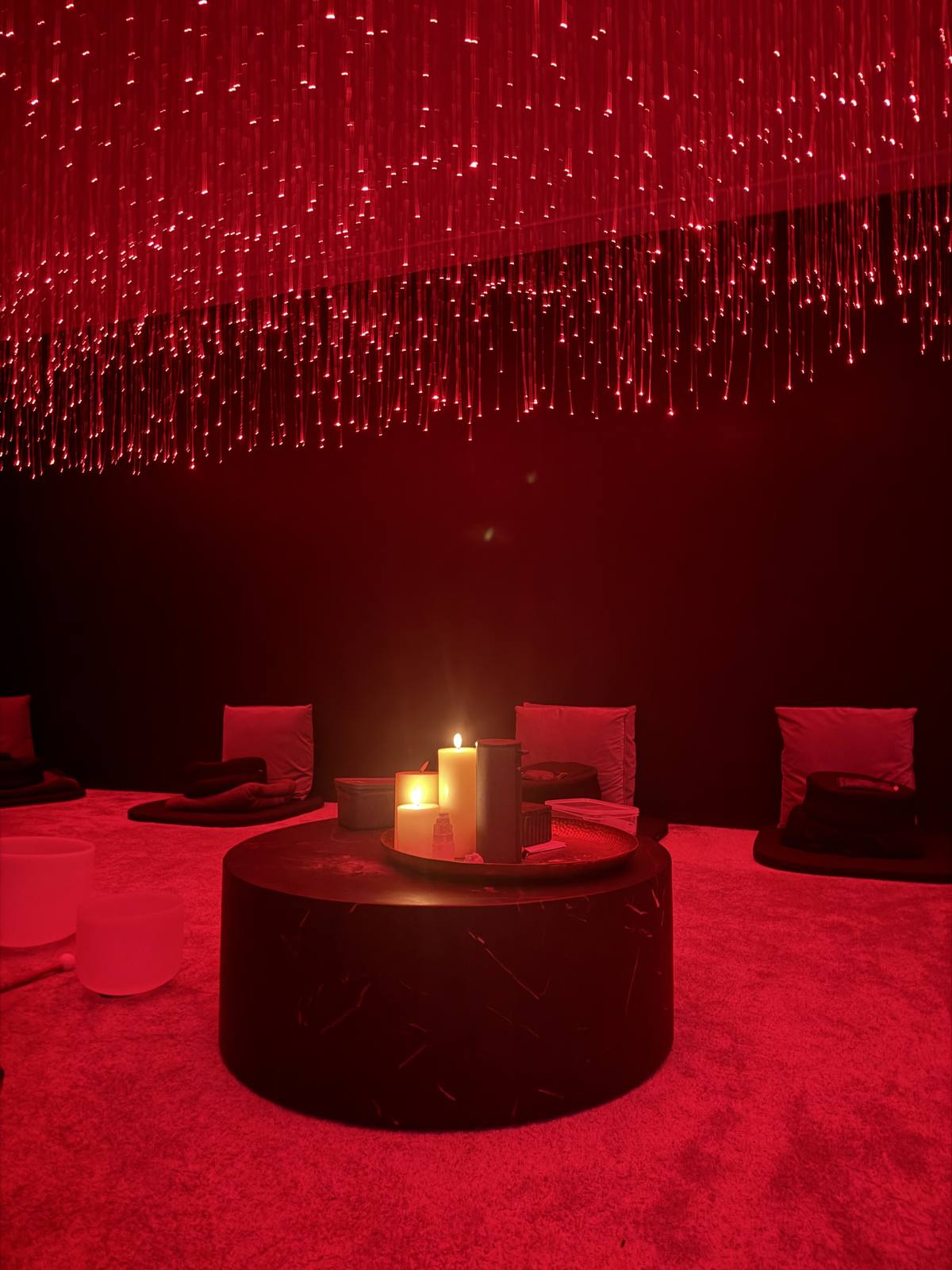 A dark room with a fibre optic ceiling set for a sound bath