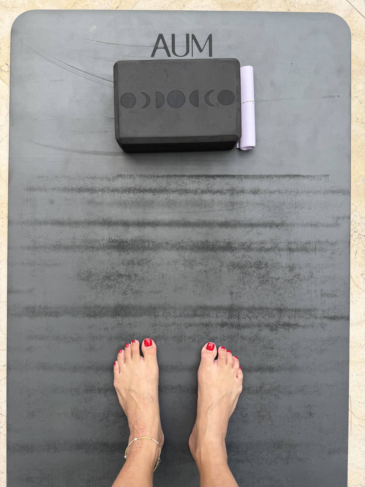 Bare feet at the top of a yoga mat