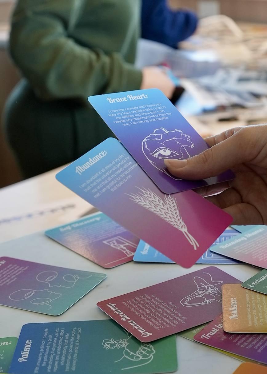 Hands holding intention cards during a workshop