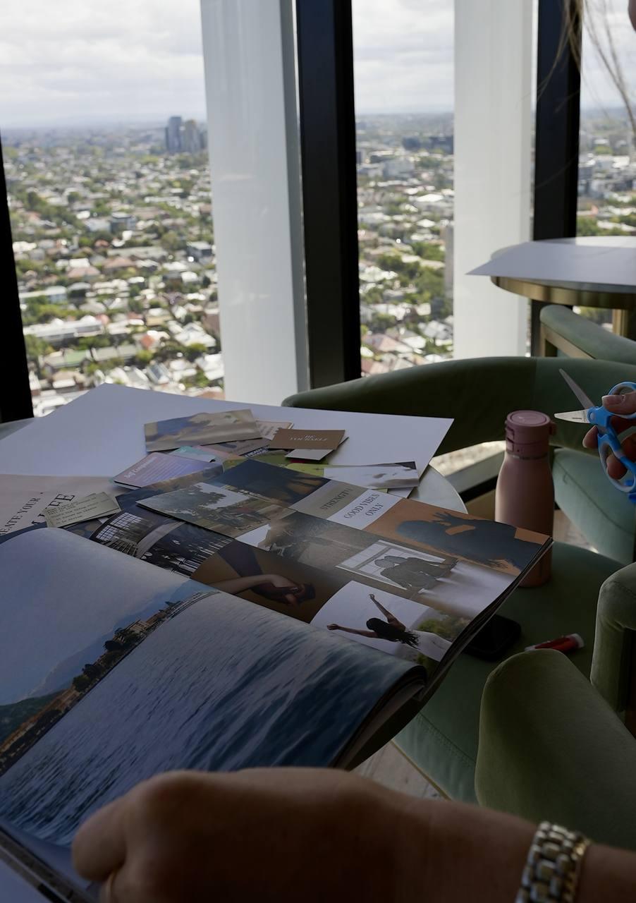 A vision board taking shape on a table with the city behind